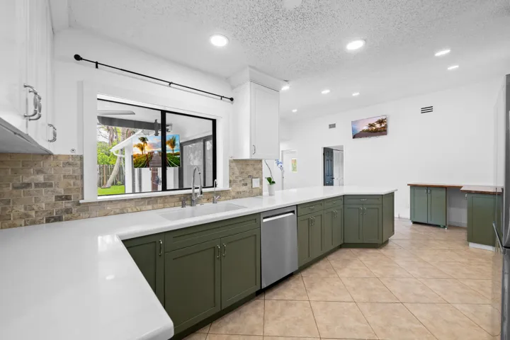 Kitchen window overlooks the pool area