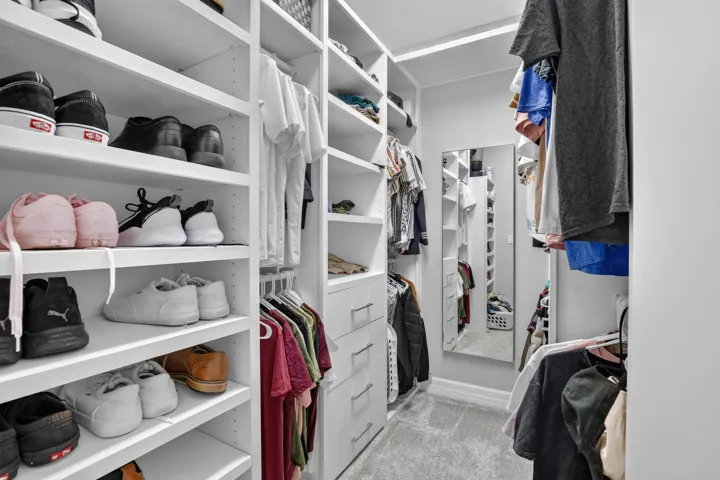 Built-in closet system with shelving, hanging rods, and drawers