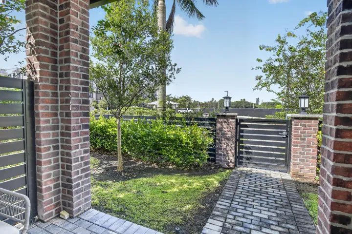 Brick pillars with integrated lighting and a matching paver pathway