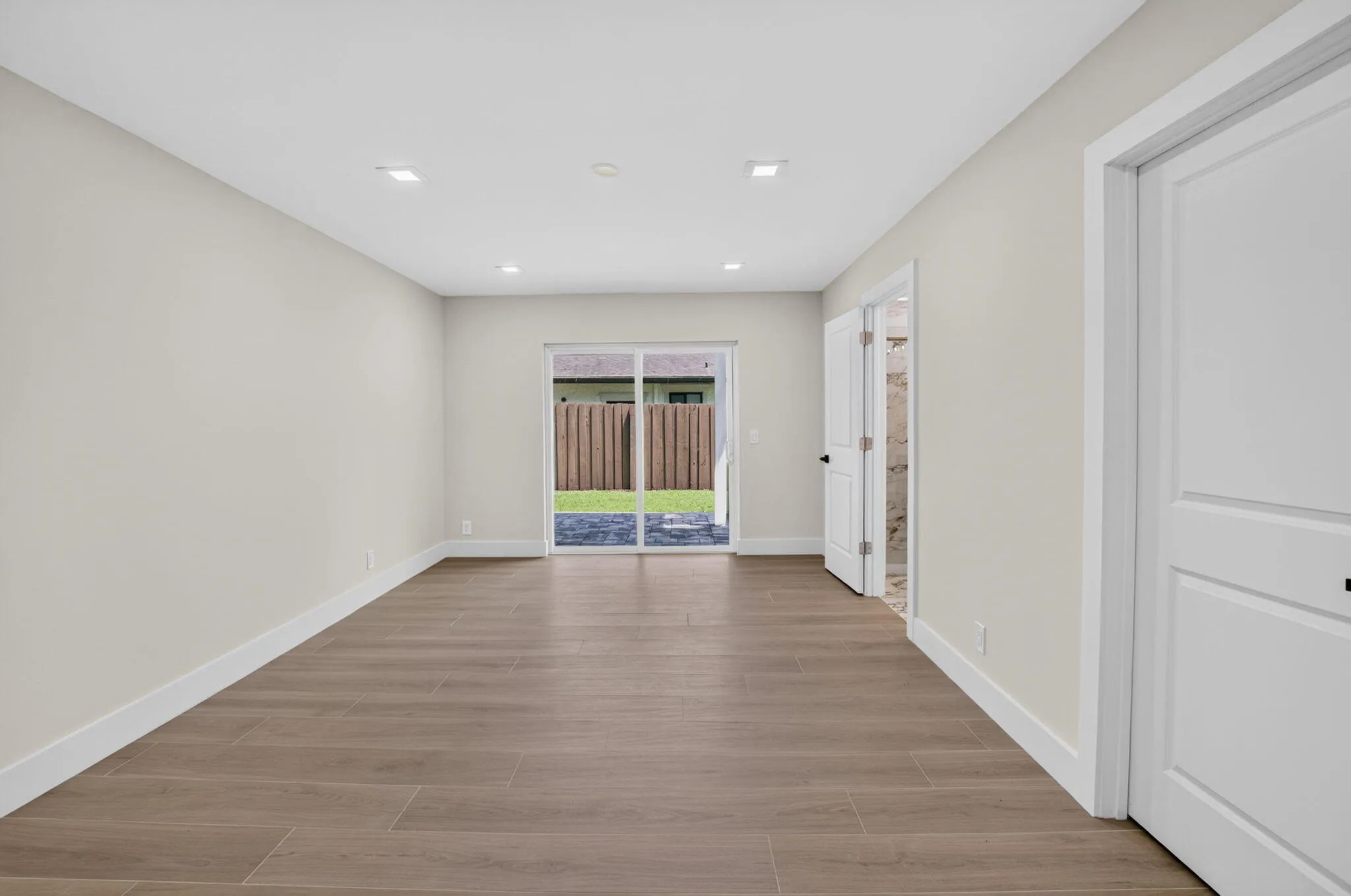 Spacious primary suite offers patio access