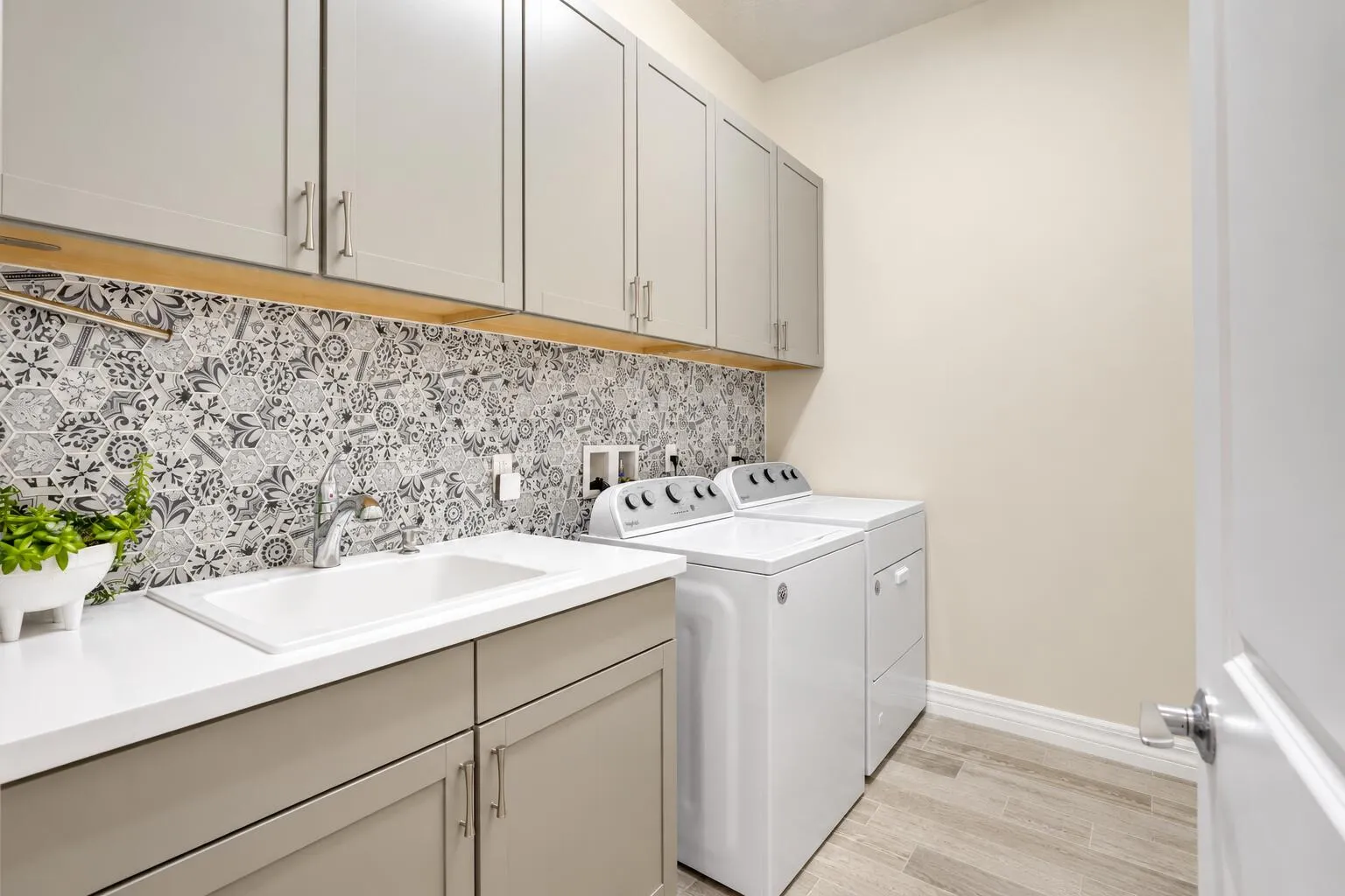 Walk-in laundry room with storage