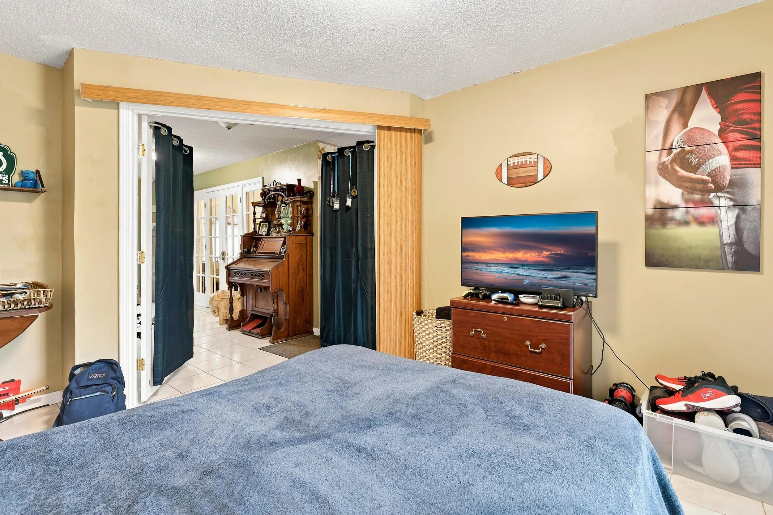 Additional bedroom view showcasing the room’s size, closet access, and neutral finishes.