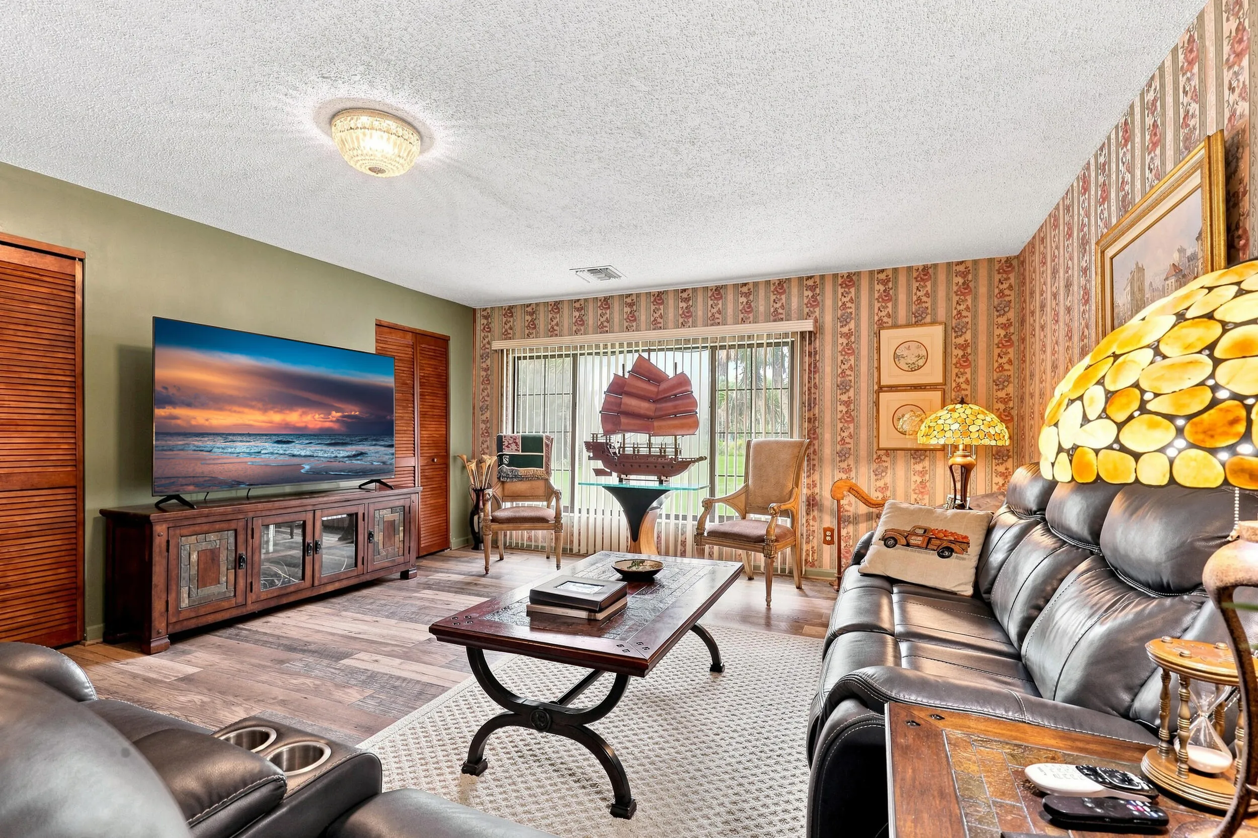 Spacious living area with updated flooring, abundant seating space, and natural light.