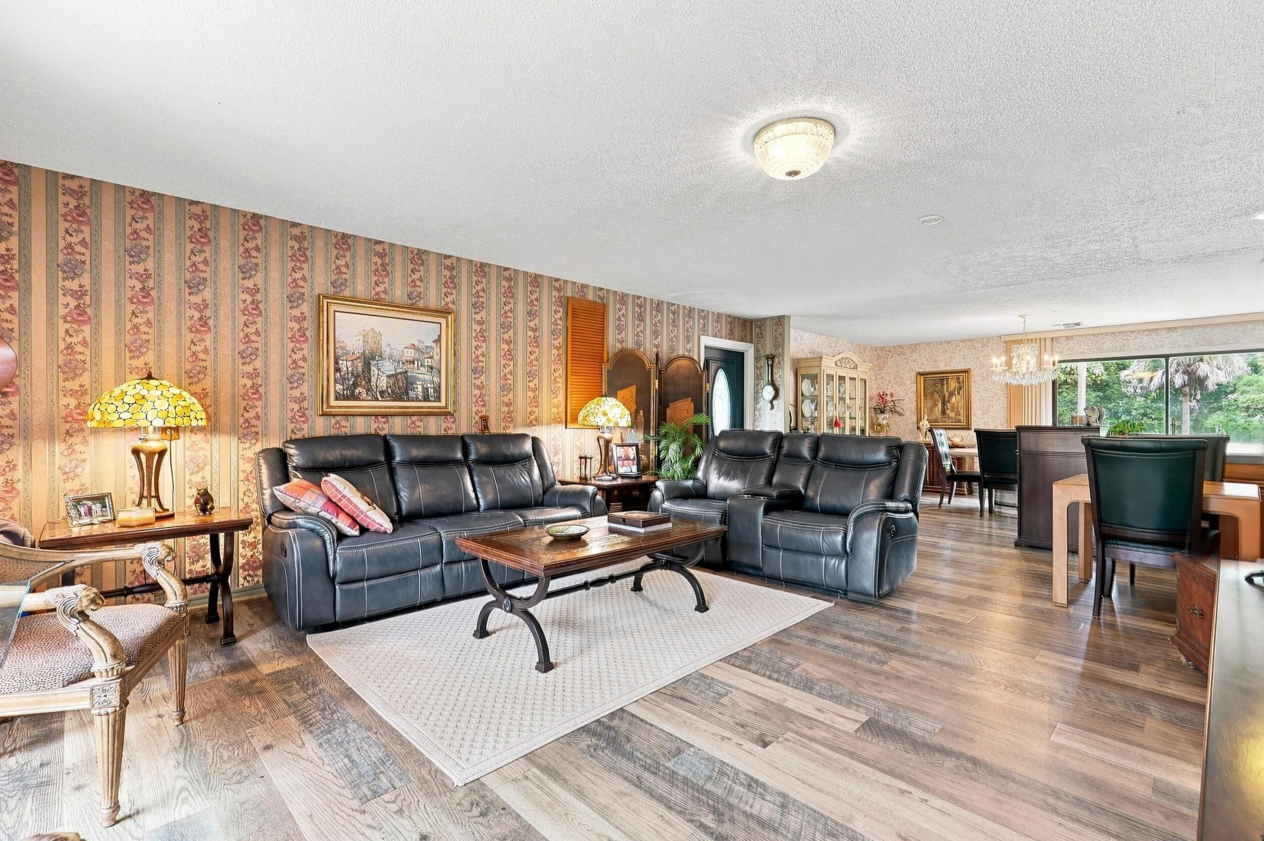 Wide interior view highlighting the comfortable living area and connection to the adjoining dining space.