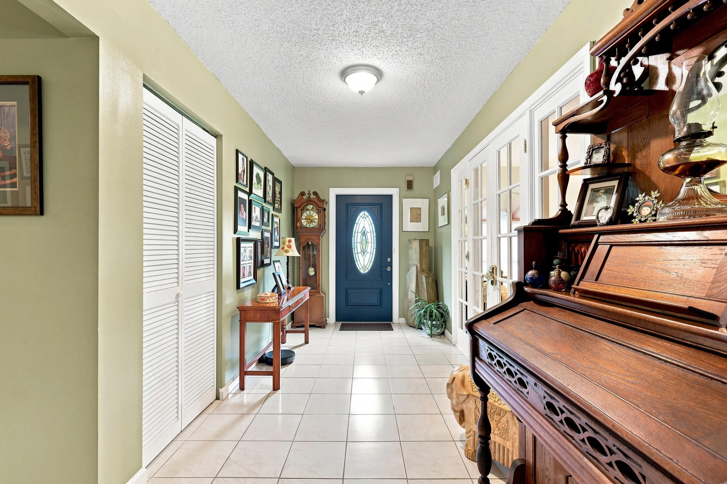 Welcoming hallway with tile flooring providing access to the home’s main living areas.
