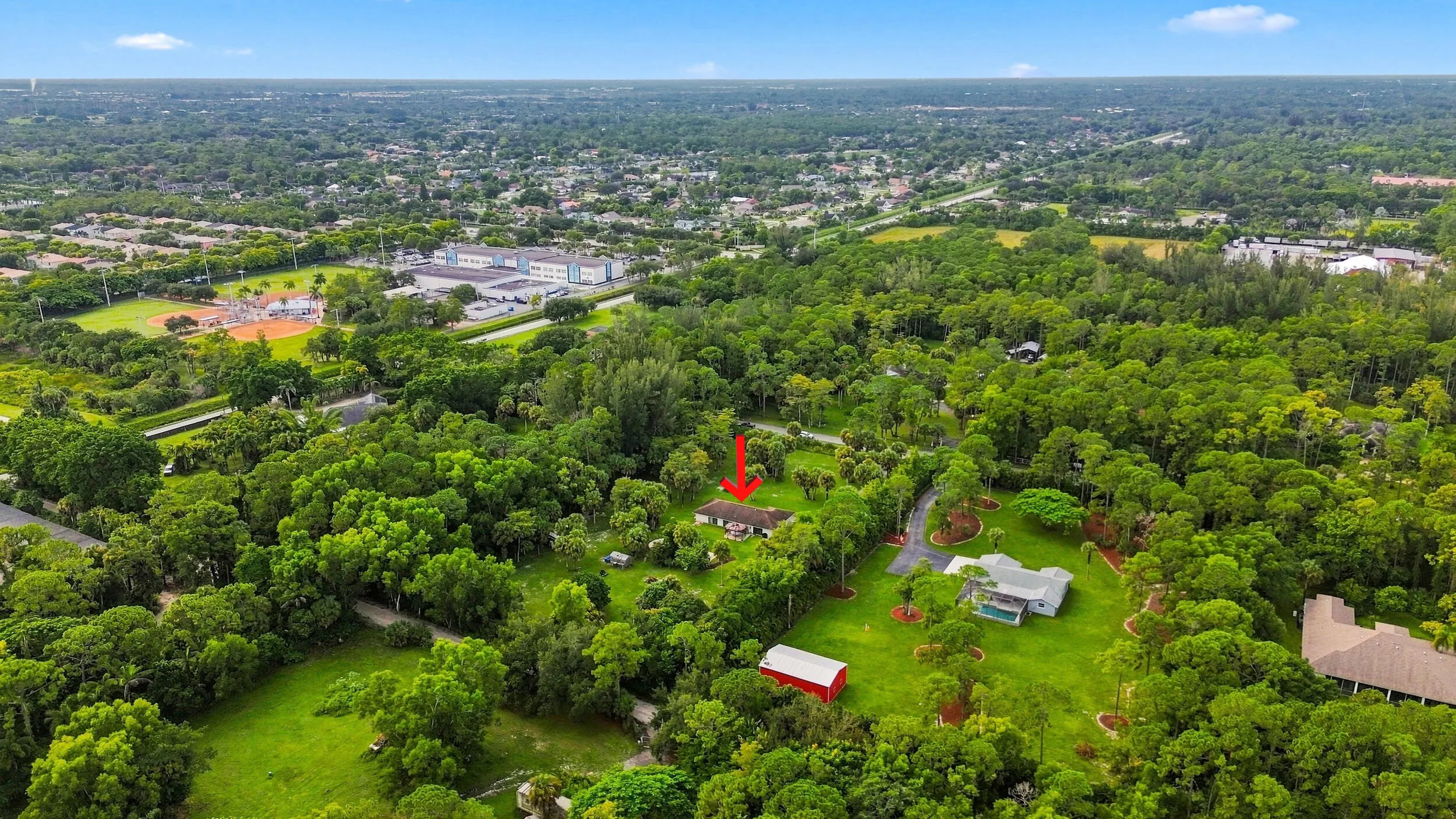 Expansive aerial view highlighting the property and surrounding rural landscape.