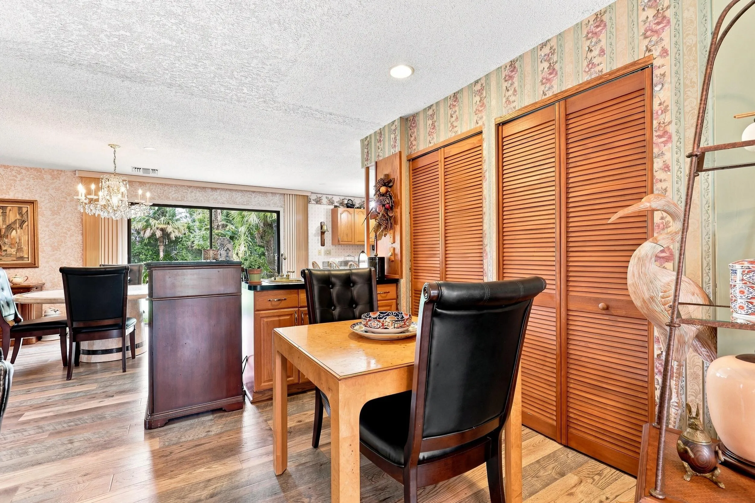 Dining space with updated flooring and convenient access to the kitchen and living areas.