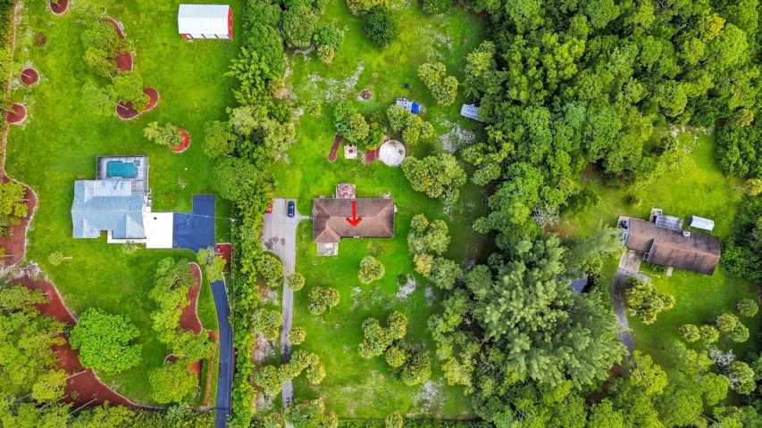 Direct aerial perspective showcasing the home, property layout, and surrounding green space.