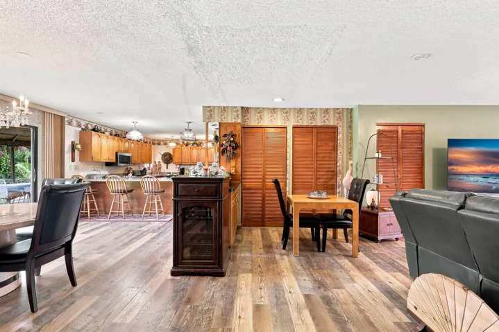 Open-concept living and dining space with updated flooring and an easy flow into the kitchen.