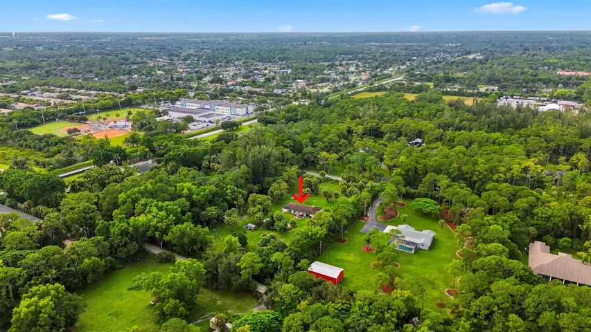Expansive aerial view highlighting the property and surrounding rural landscape.
