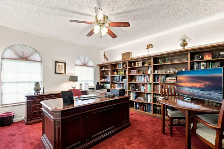 Additional office view showcasing the generous built-in bookcases and flexible workspace.
