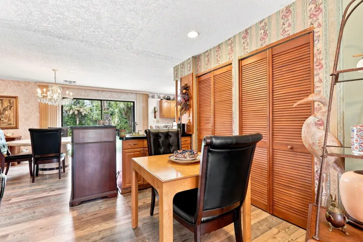 Dining space with updated flooring and convenient access to the kitchen and living areas.