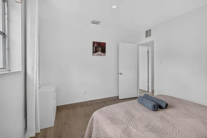 Third Bedroom with Wood-Look Flooring and Hallway Access
