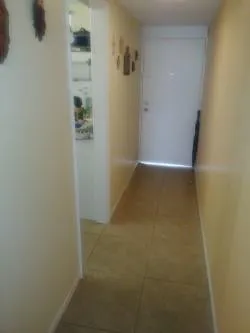 Entry corridor to the exit door and kitchen