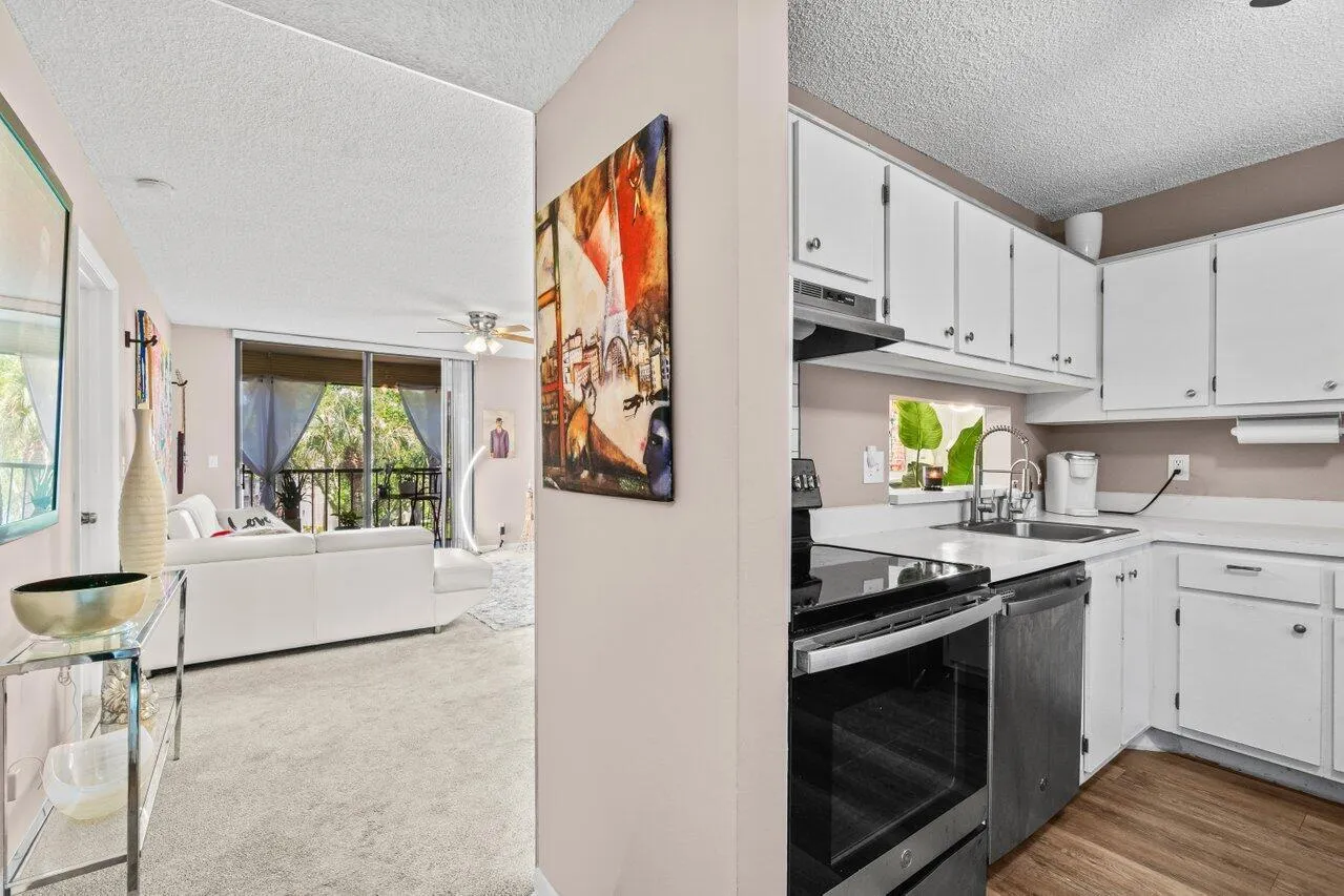 Kitchen next to the hallway entering living space