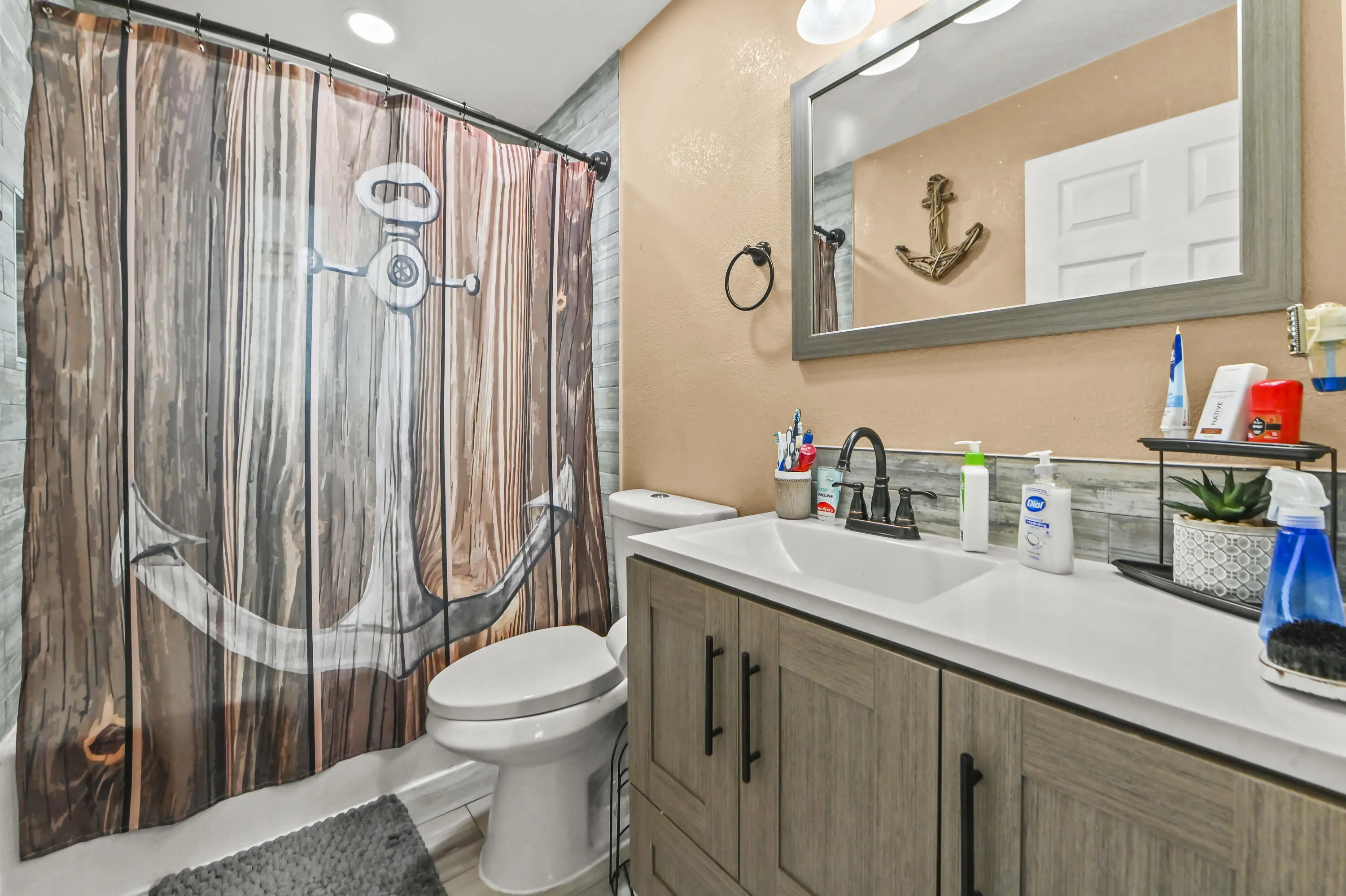 Modern vanity with integrated sink, wood-finish cabinetry, and matte black faucet