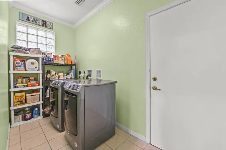Ceramic tile flooring, crown molding, and a glass block window