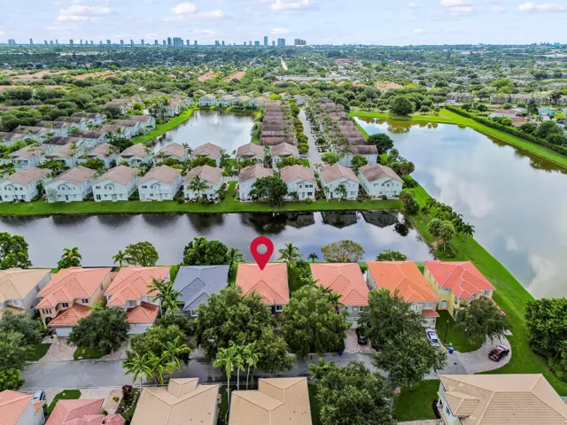 Aerial perspective highlighting residential properties, natural waterways, and a distant city skyline
