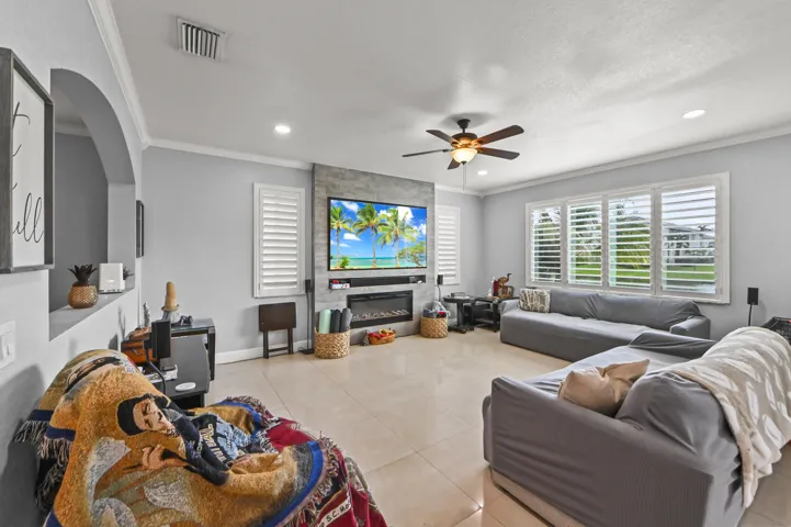 Recessed lighting, crown molding, and a ceiling fan with integrated lighting