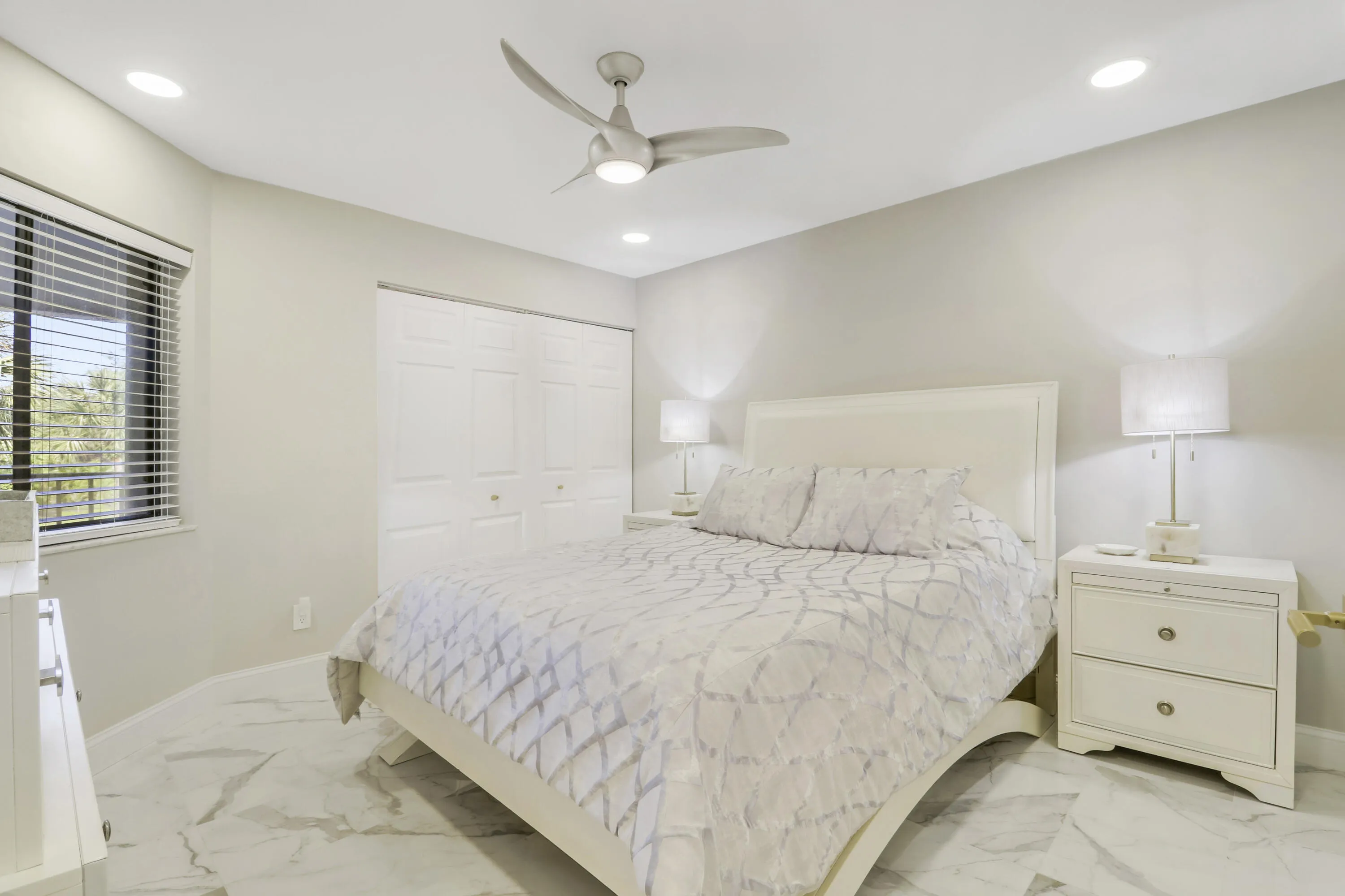 White paneled bi-fold closet doors, recessed lighting, and a contemporary ceiling fan