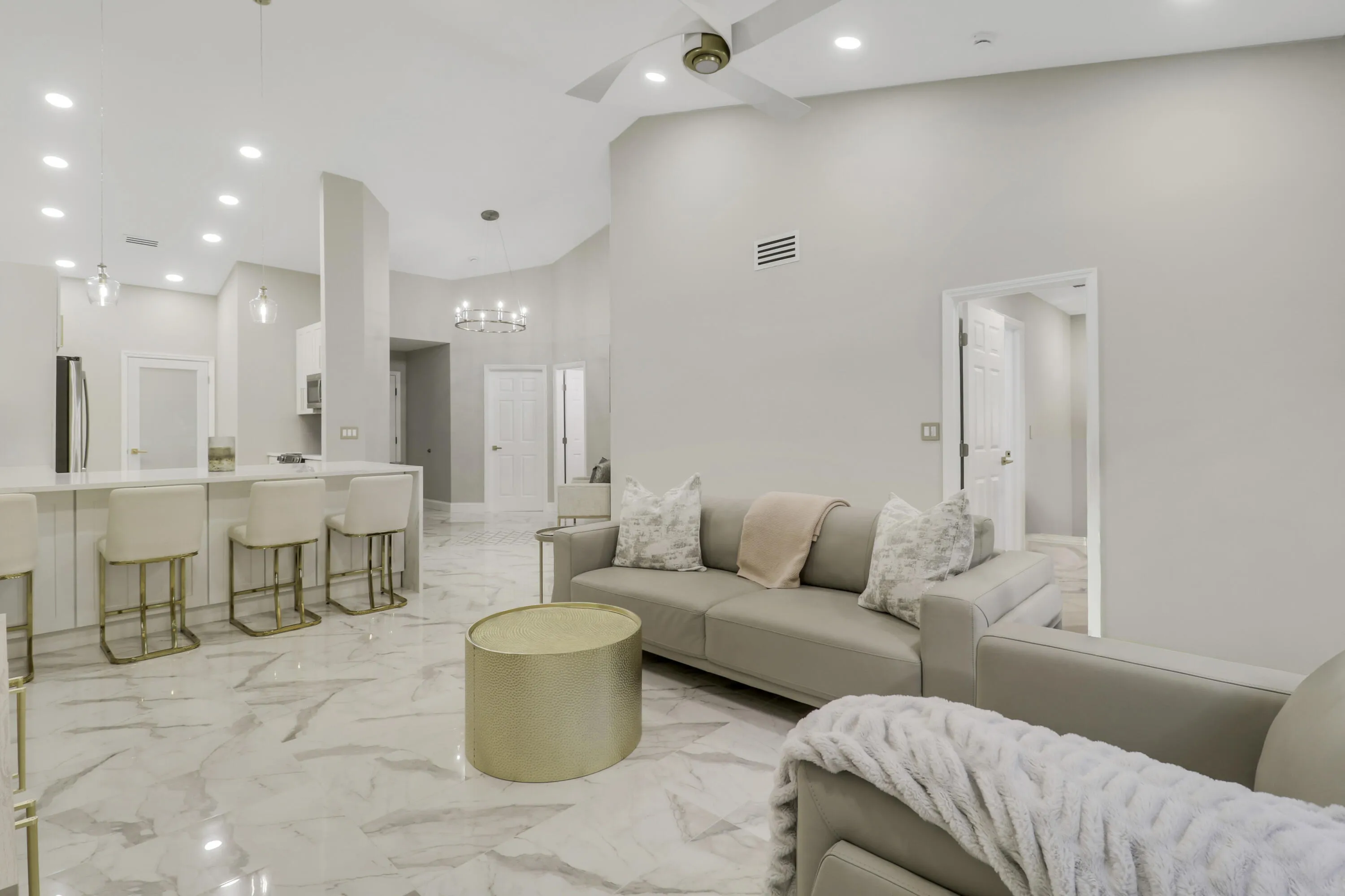 Vaulted ceilings, recessed lighting, and large format tile flooring