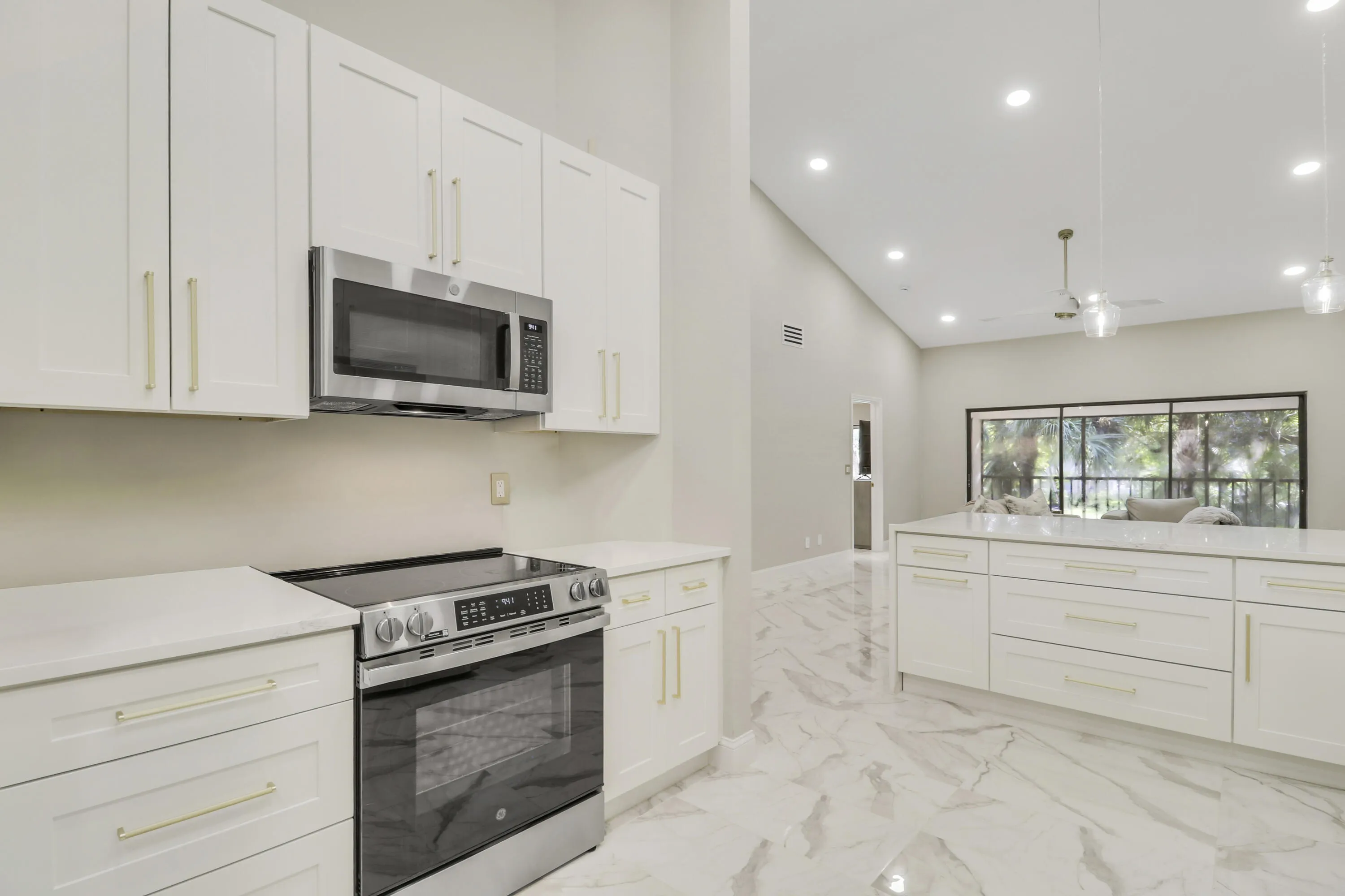 Modern kitchen featuring white shaker cabinetry, stainless steel appliances, and sleek countertops