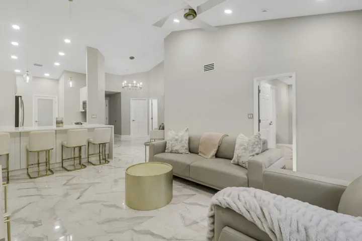 Vaulted ceilings, recessed lighting, and large format tile flooring