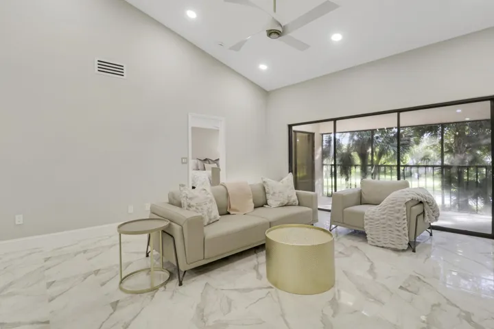 Vaulted ceiling with recessed lighting and a ceiling fan