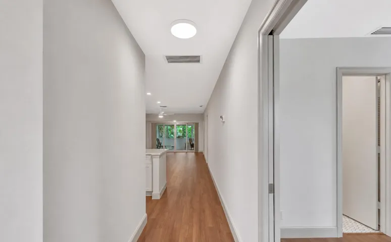 Wood-finish flooring throughout the hallway