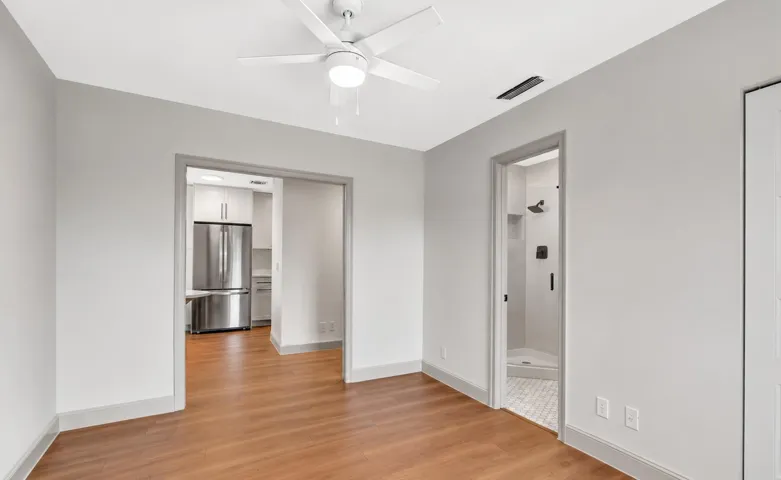 Wood-finish flooring throughout, complemented by light gray wall tones and white trim