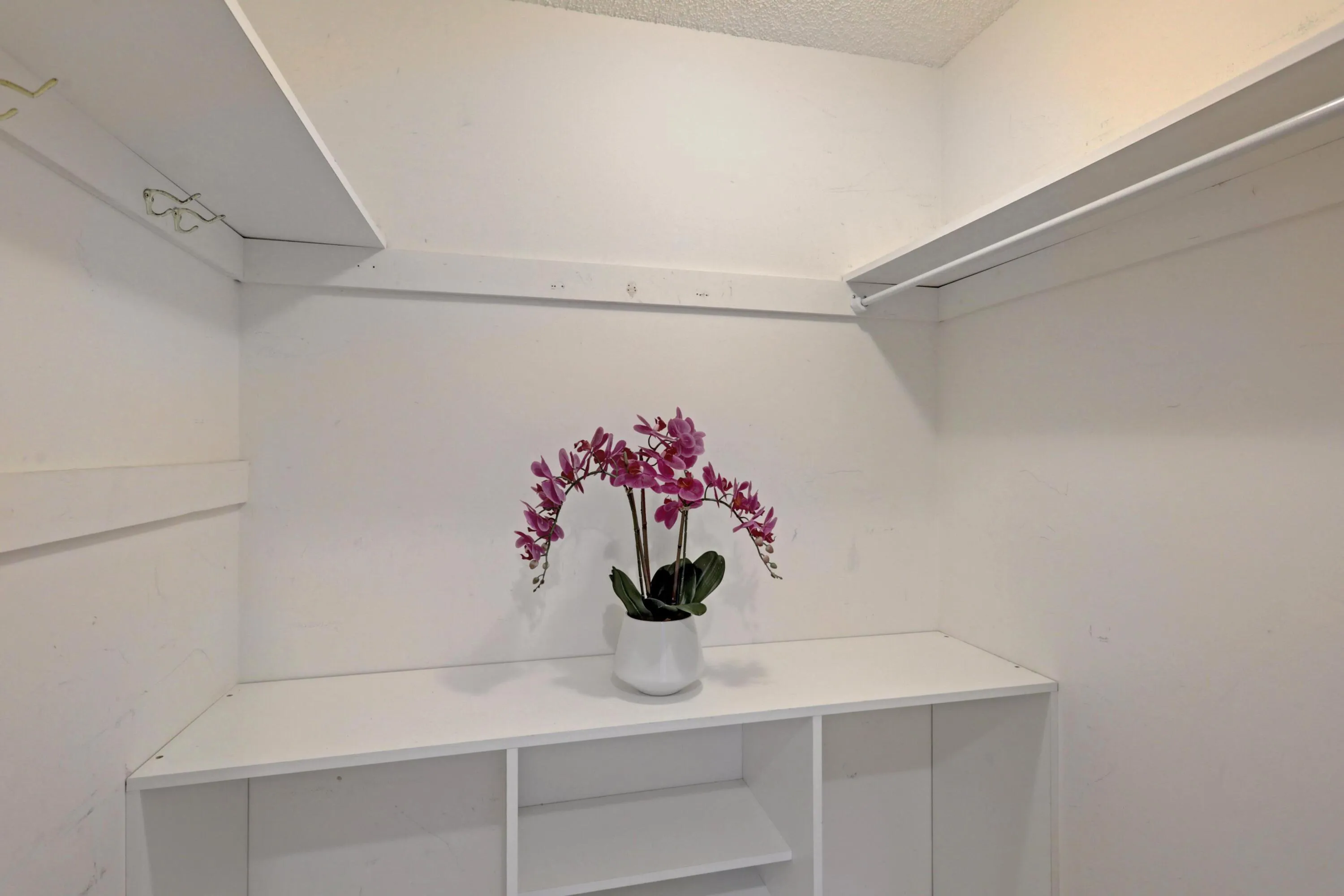 Integrated closet system featuring multiple shelves and a hanging rod