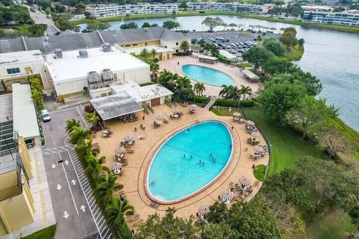Main Clubhouse - Expansive amenity area featuring two large swimming pools, Shuffleboard, Bocce, and Sailing