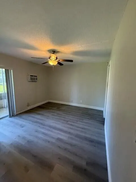 Spacious Bedroom features Wood-finish laminate flooring, ceiling fan, and ensuite Full Bath