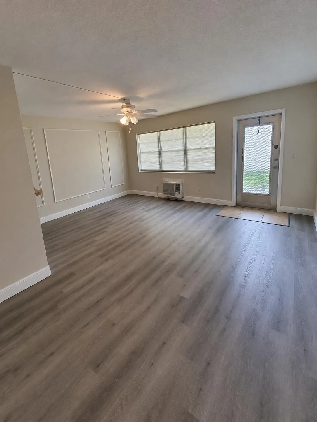 Updated Kitchen w White cabinetry, light-toned countertops, stainless steel sink, and ceramic tile flooring