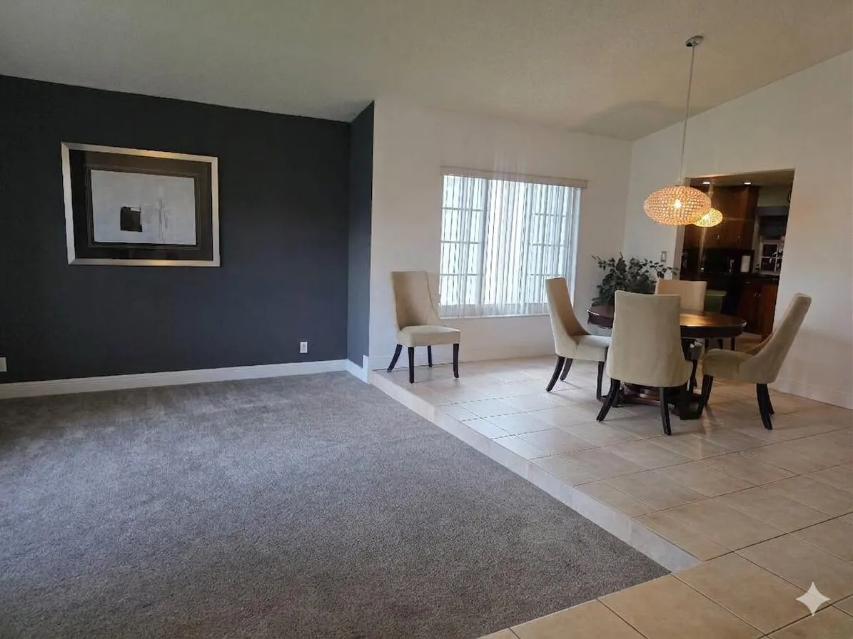Large foyer featuring sunken living room and open dining room.