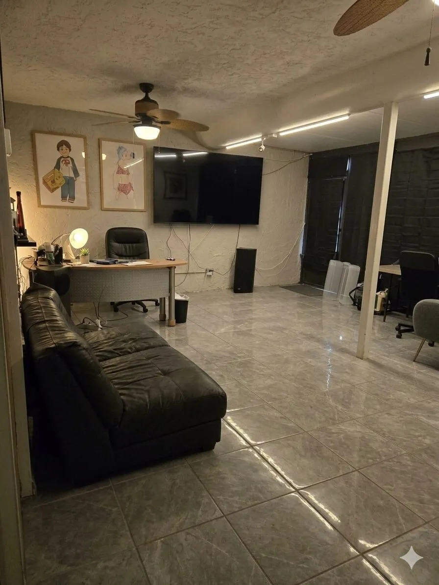 Spacious room featuring large format tile flooring, multiple ceiling fans, and track lighting