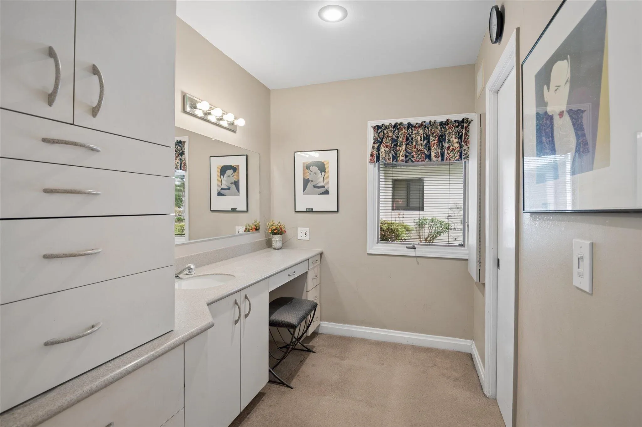 Second dressing area with door to dressing area and door to closet off. Window to butterfly garden.