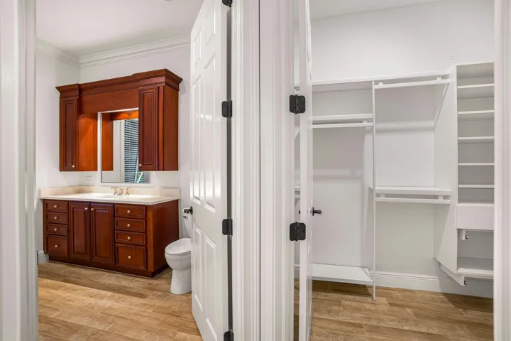 PRIMARY SUITE FEATURING SEPARATE HIS AND HER BATH AREAS WITH GENEROUS WALK IN CLOSET SPACE