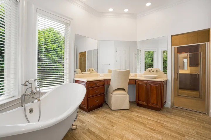 PRIMARY SUITE FEATURING SEPARATE HIS AND HER BATH AREAS WITH GENEROUS WALK IN CLOSET SPACE
