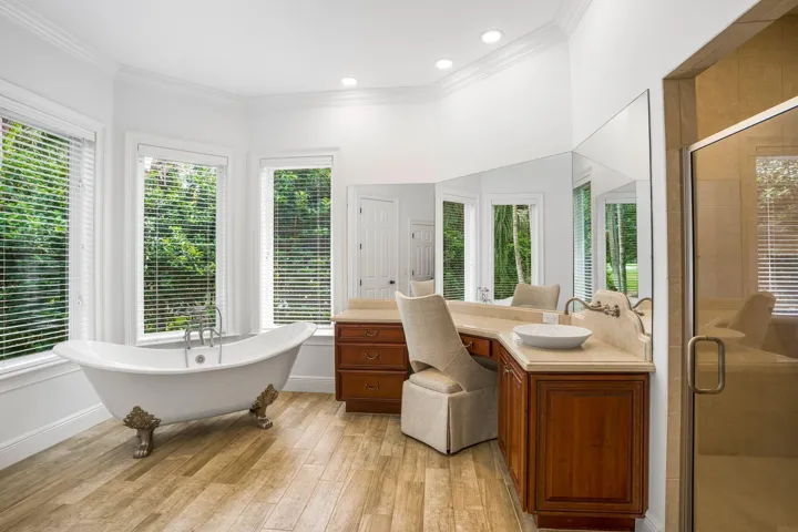 PRIMARY SUITE FEATURING SEPARATE HIS AND HER BATH AREAS WITH GENEROUS WALK IN CLOSET SPACE