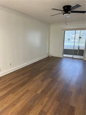 Large living room has new flooring, screened patio overlooks garden area.