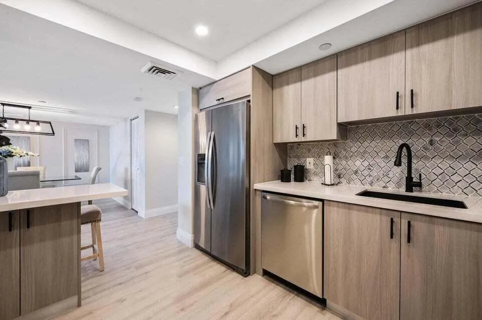 All stainless steel appliances including wine cooler by the bar area.