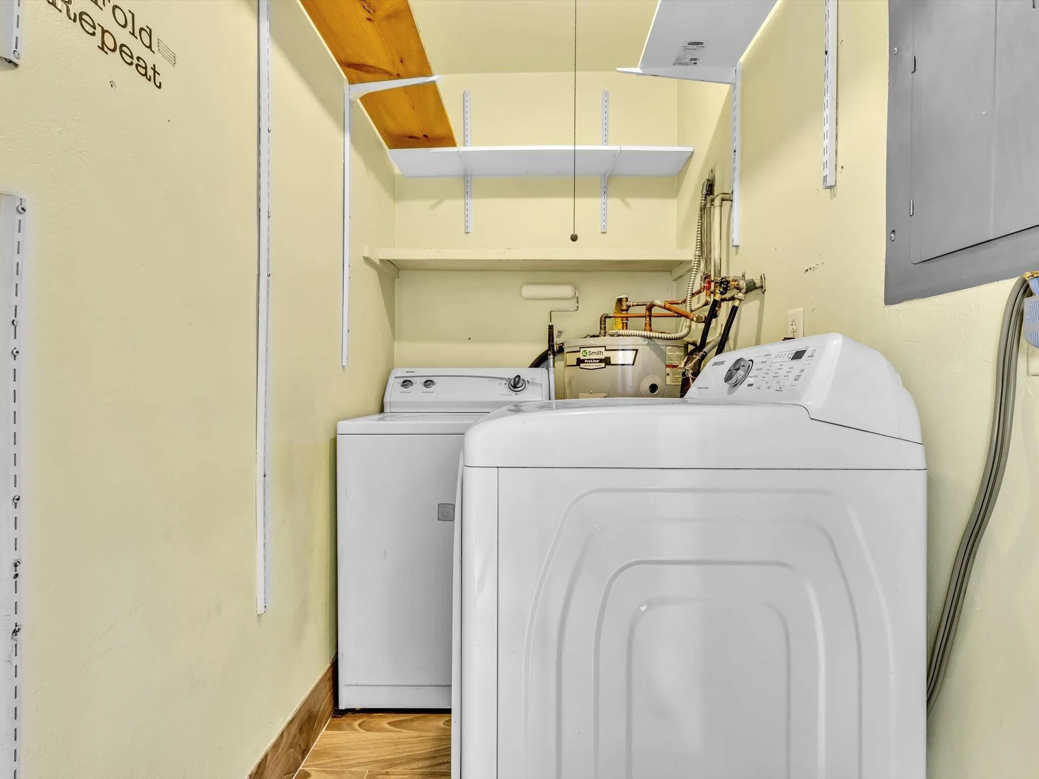 Dedicated laundry closet/room area with wood-finish vinyl flooring