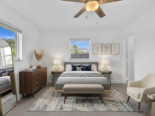 VIRTUALLY STAGED. Bedroom with wood-finish ceiling fan with integrated lighting, and light grey vinyl flooring
