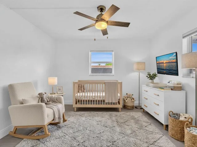 VIRTUALLY STAGED. Bedroom with wood-finish ceiling fan with integrated lighting, and light grey vinyl flooring