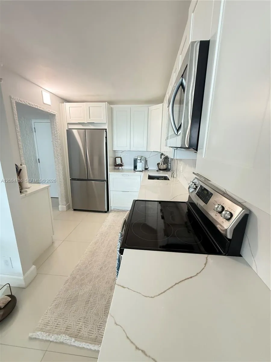 with white cabinets quartz countertops and newer dish washer