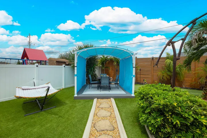 Covered gazebo with seating, turf yard and paver walkway