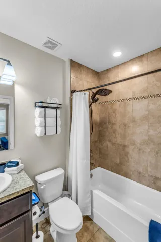 Guest bath with tub/shower combo and tiled surround