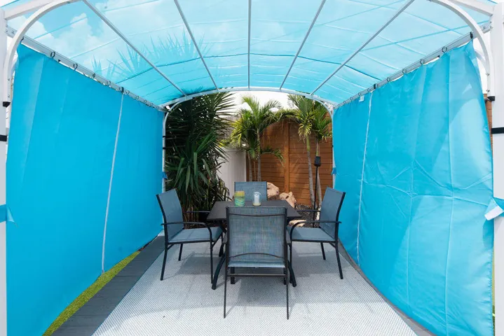 Covered outdoor dining gazebo with table and chairs