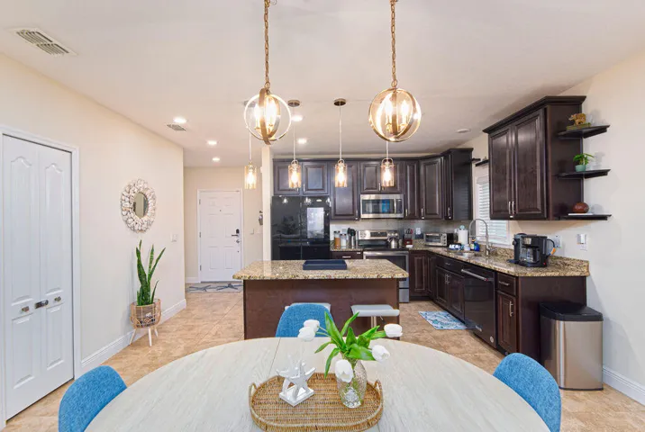 Kitchen featuring dark wood cabinetry, stainless steel appliances, and light-toned countertop